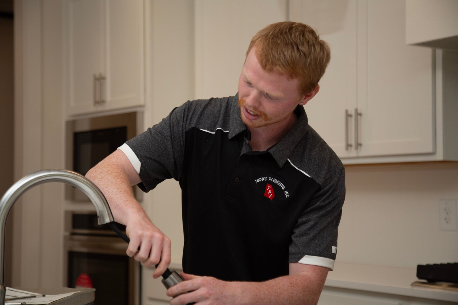 Plumber working on kitchen sink